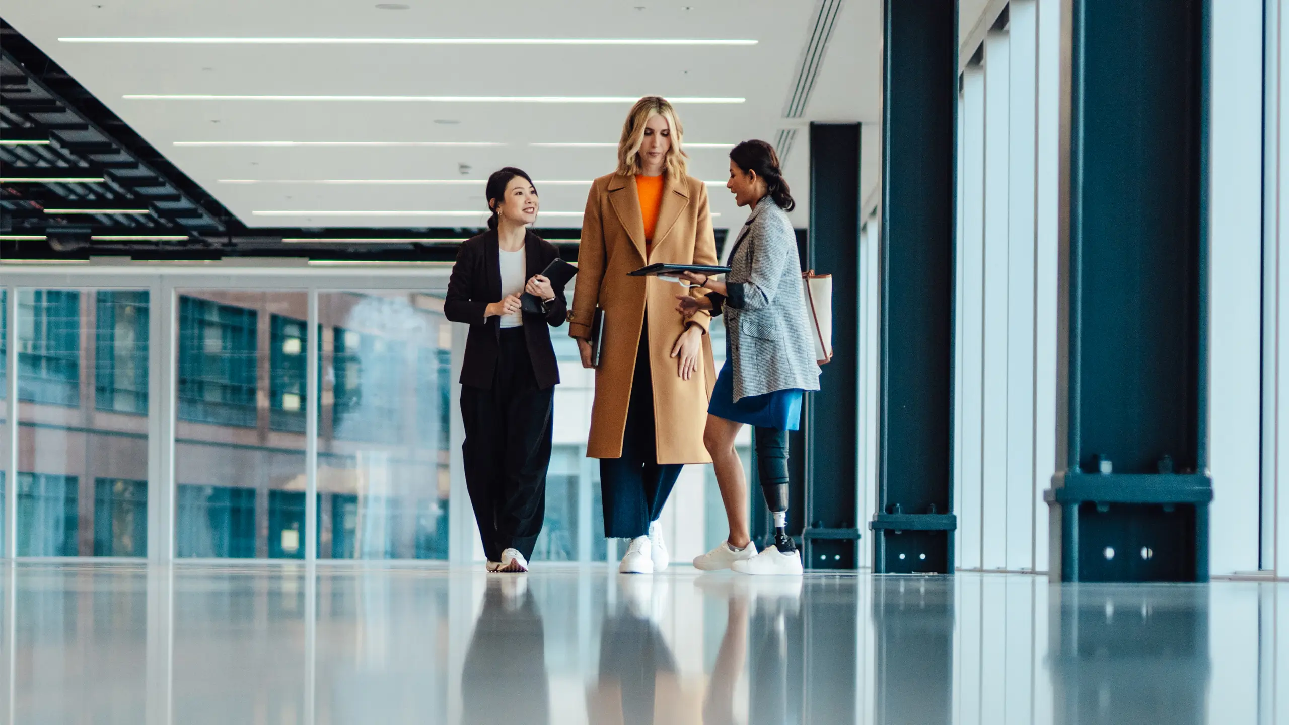 multi-racial group of businesswomen viewing new office space with an estate agent